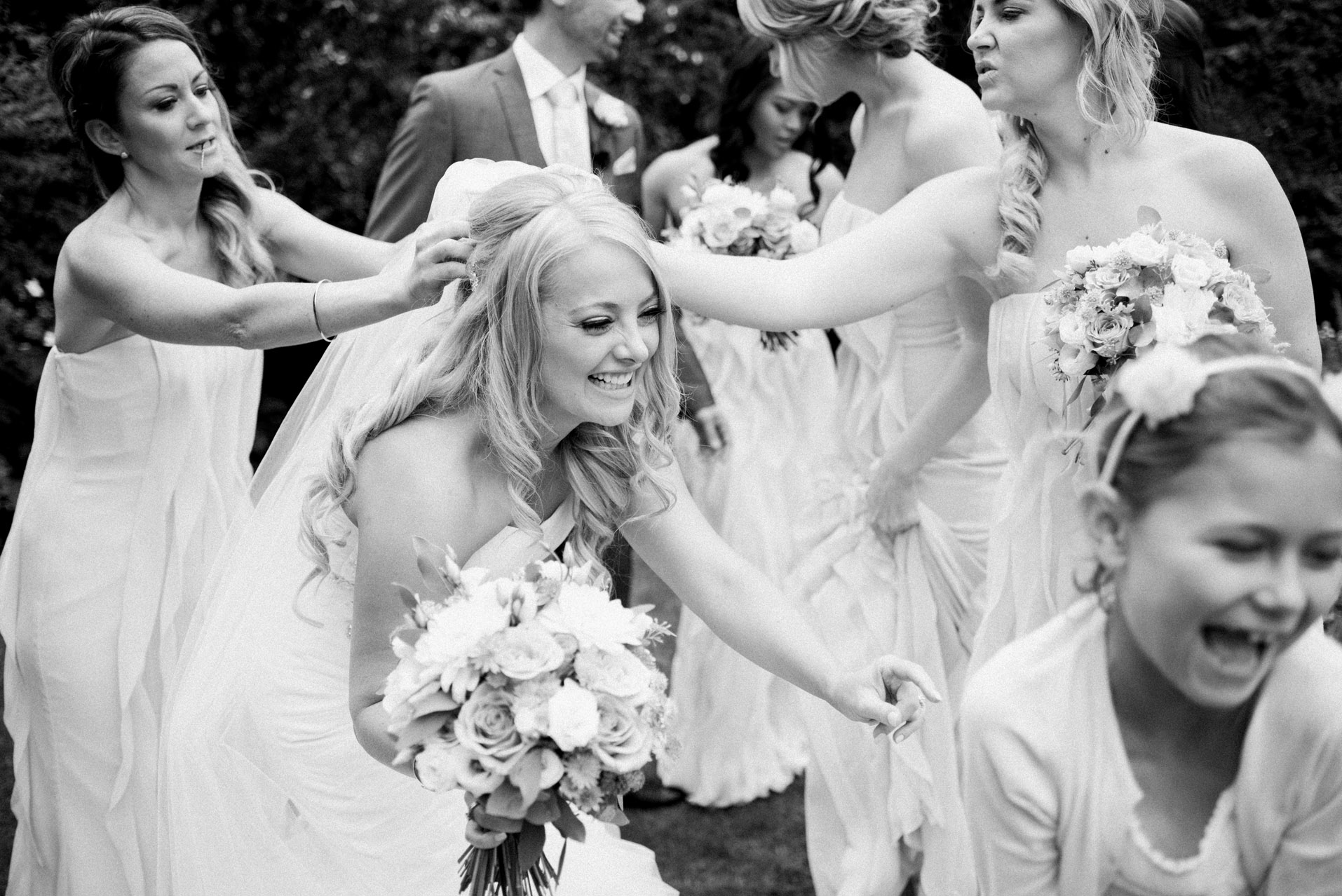 bride playing with flower girl 