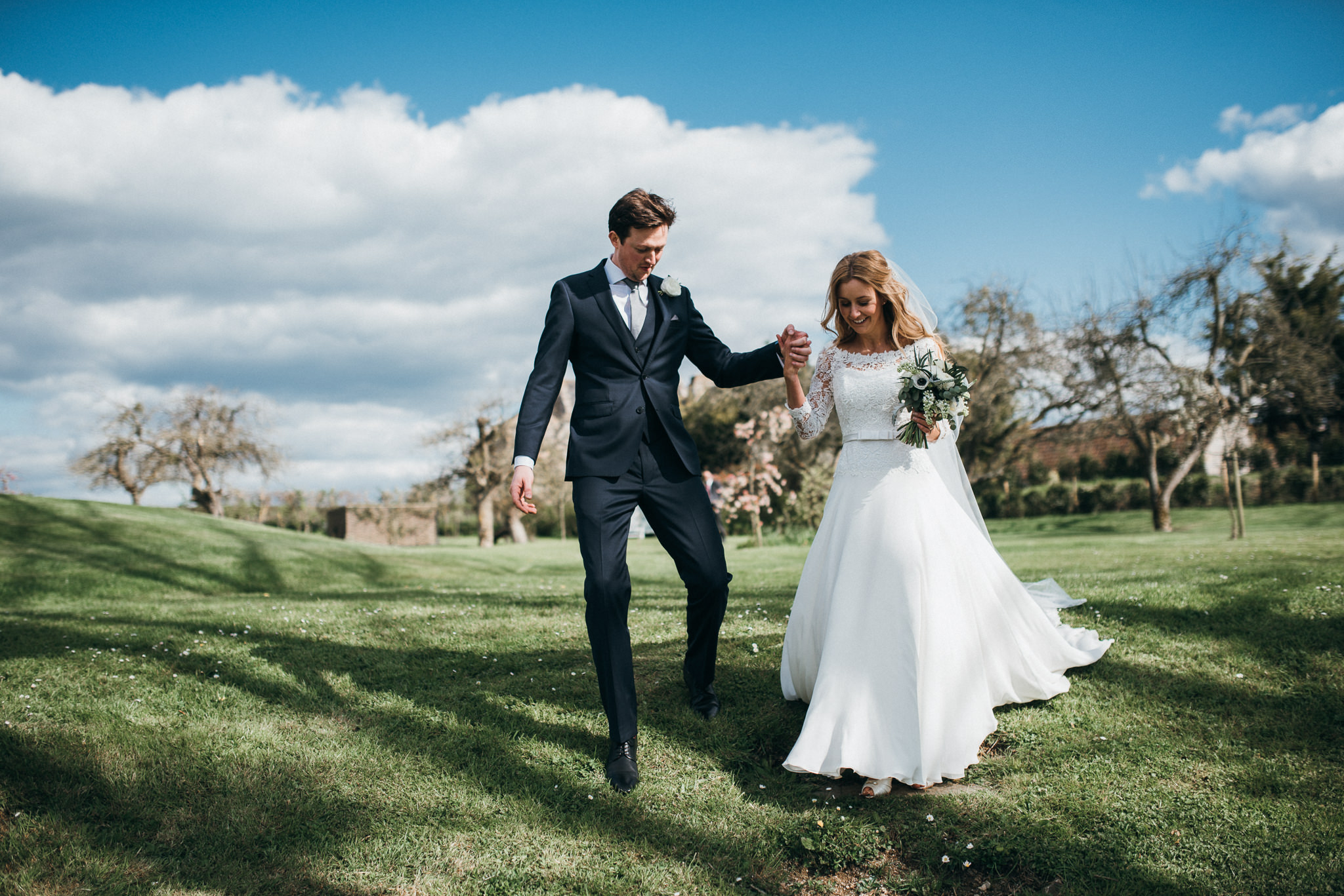 bride and groom walking  together at Almonry Barn, Somerset