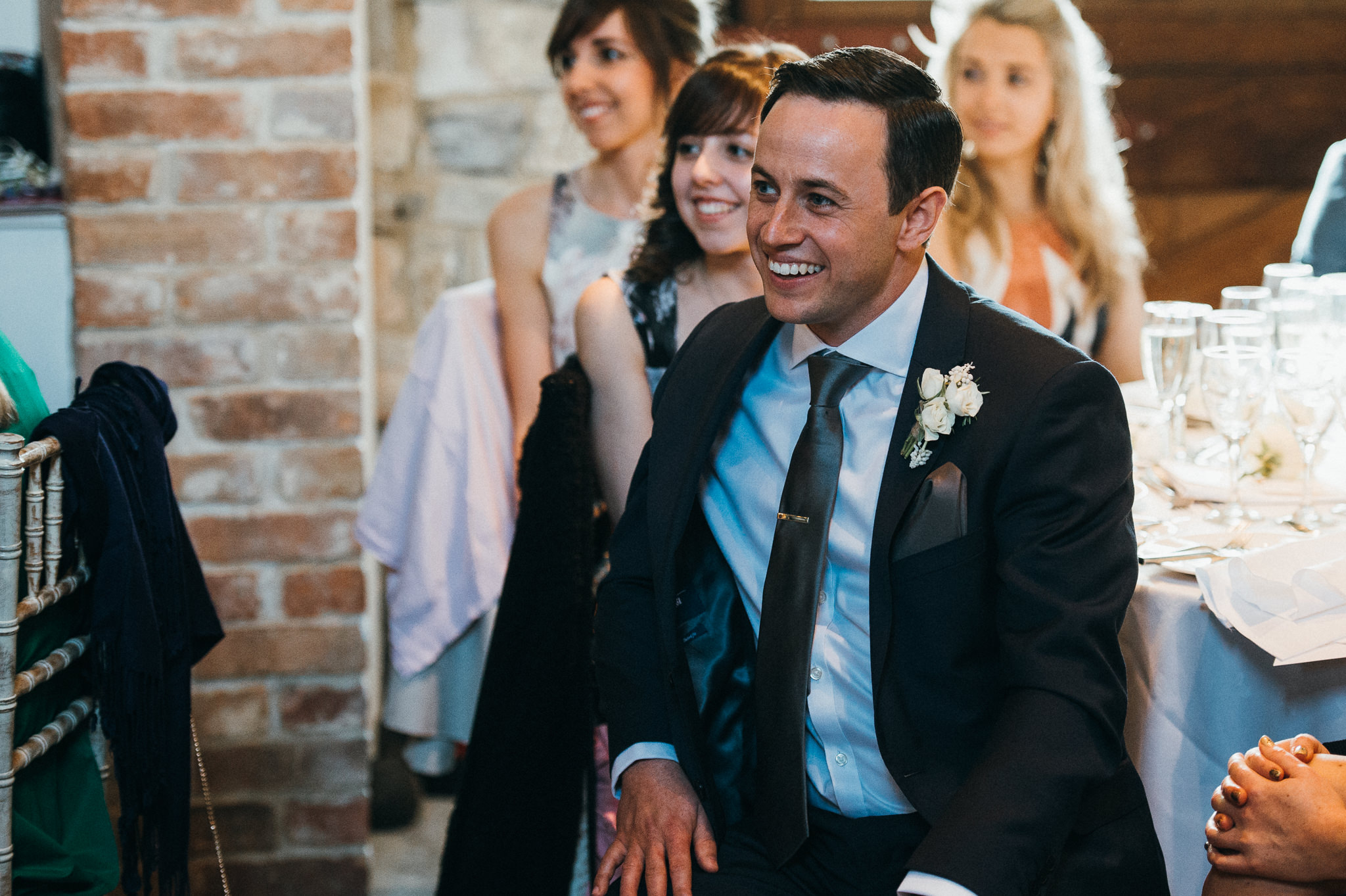 guests react to speech at wedding at the almonry barn