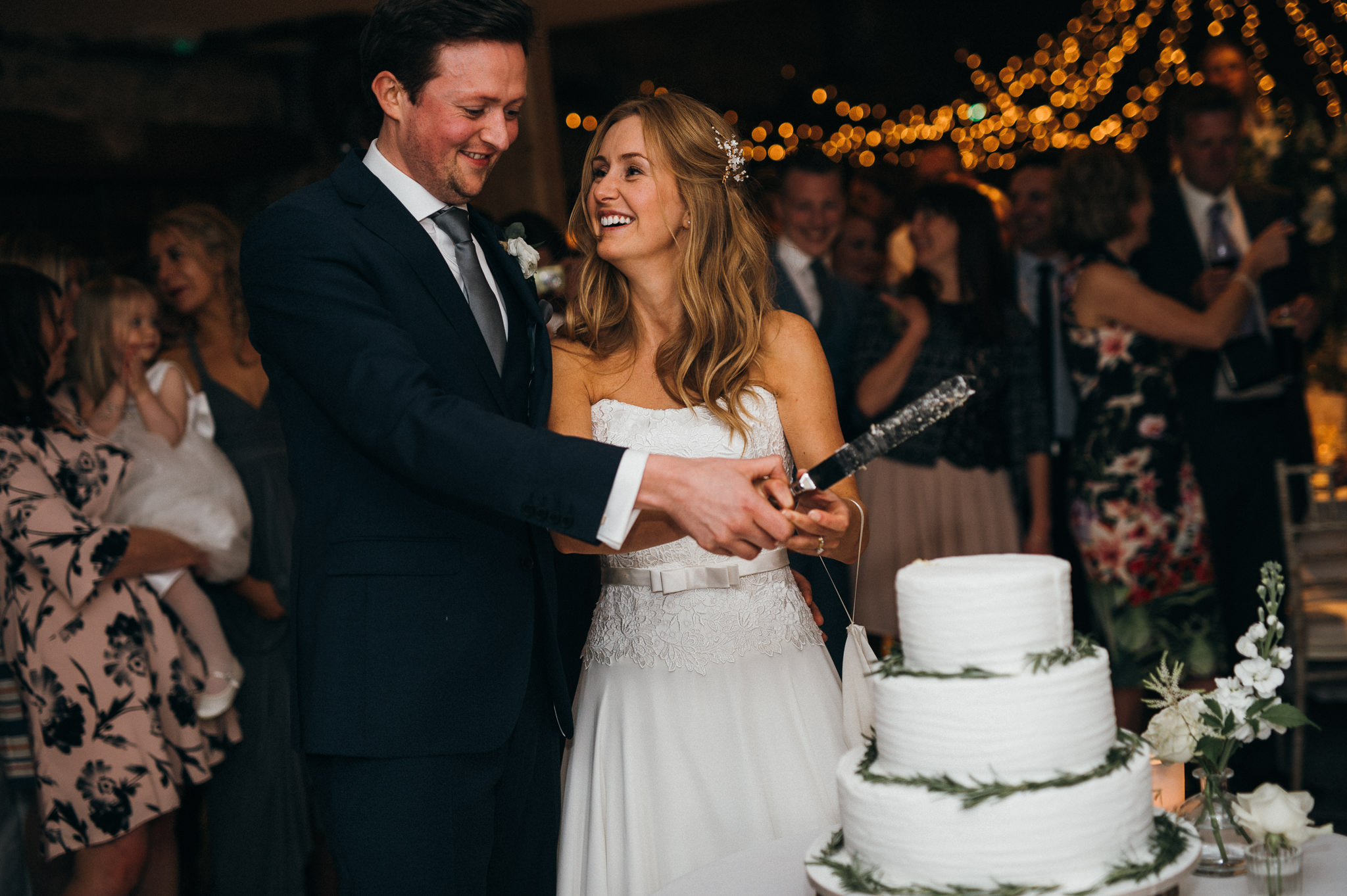 bride and groom cut cake almonry barn