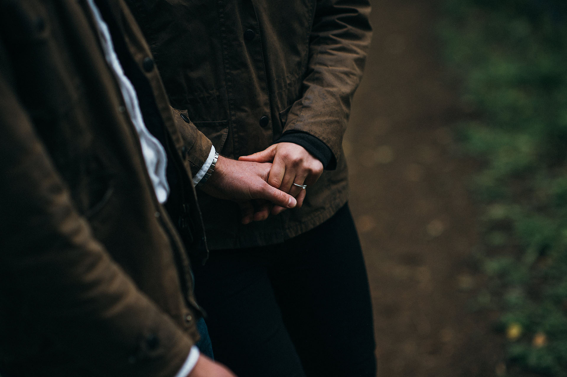 Holding hands during engagement photographs