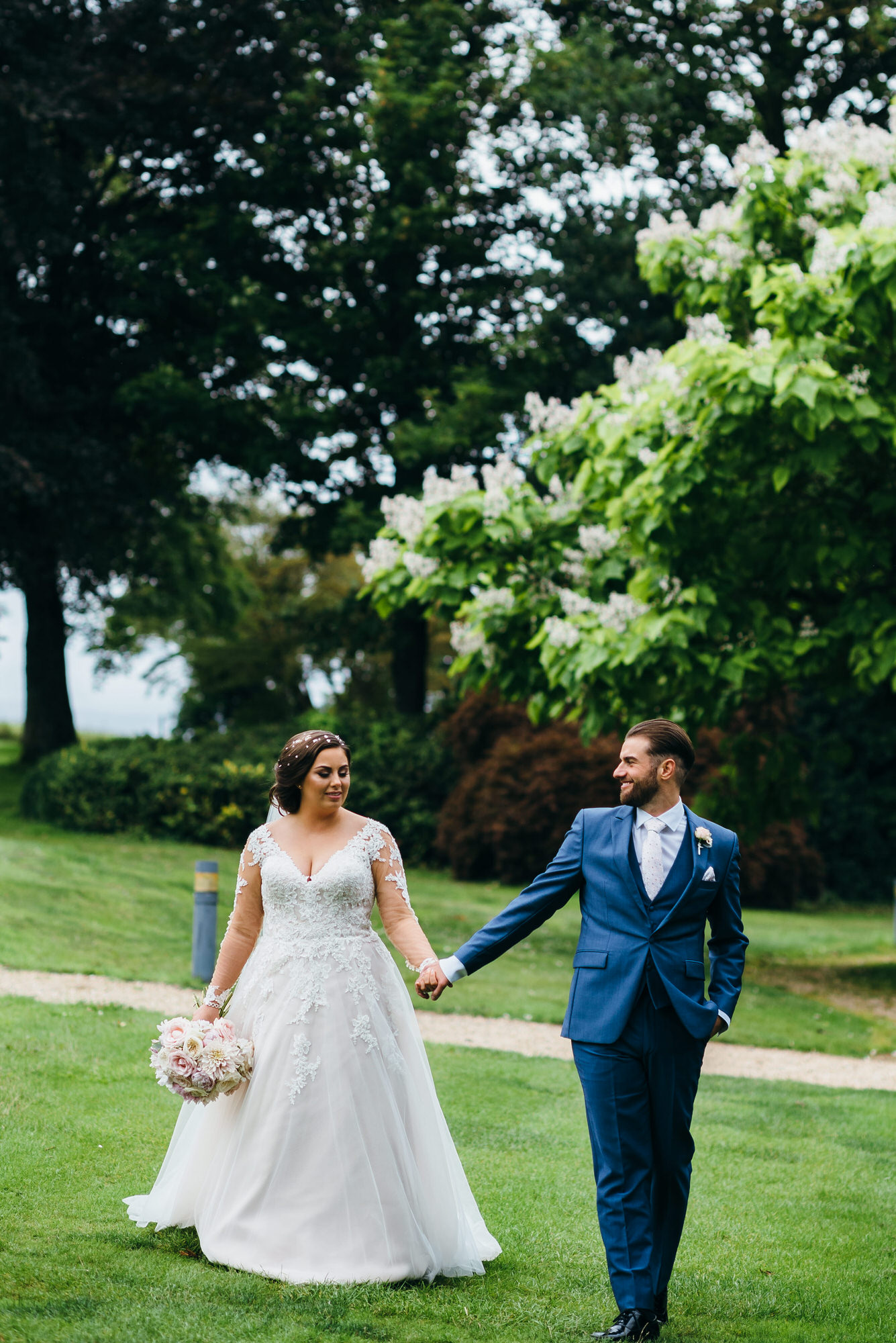 Bride and Groom walks gardens at Coombe Lodge 