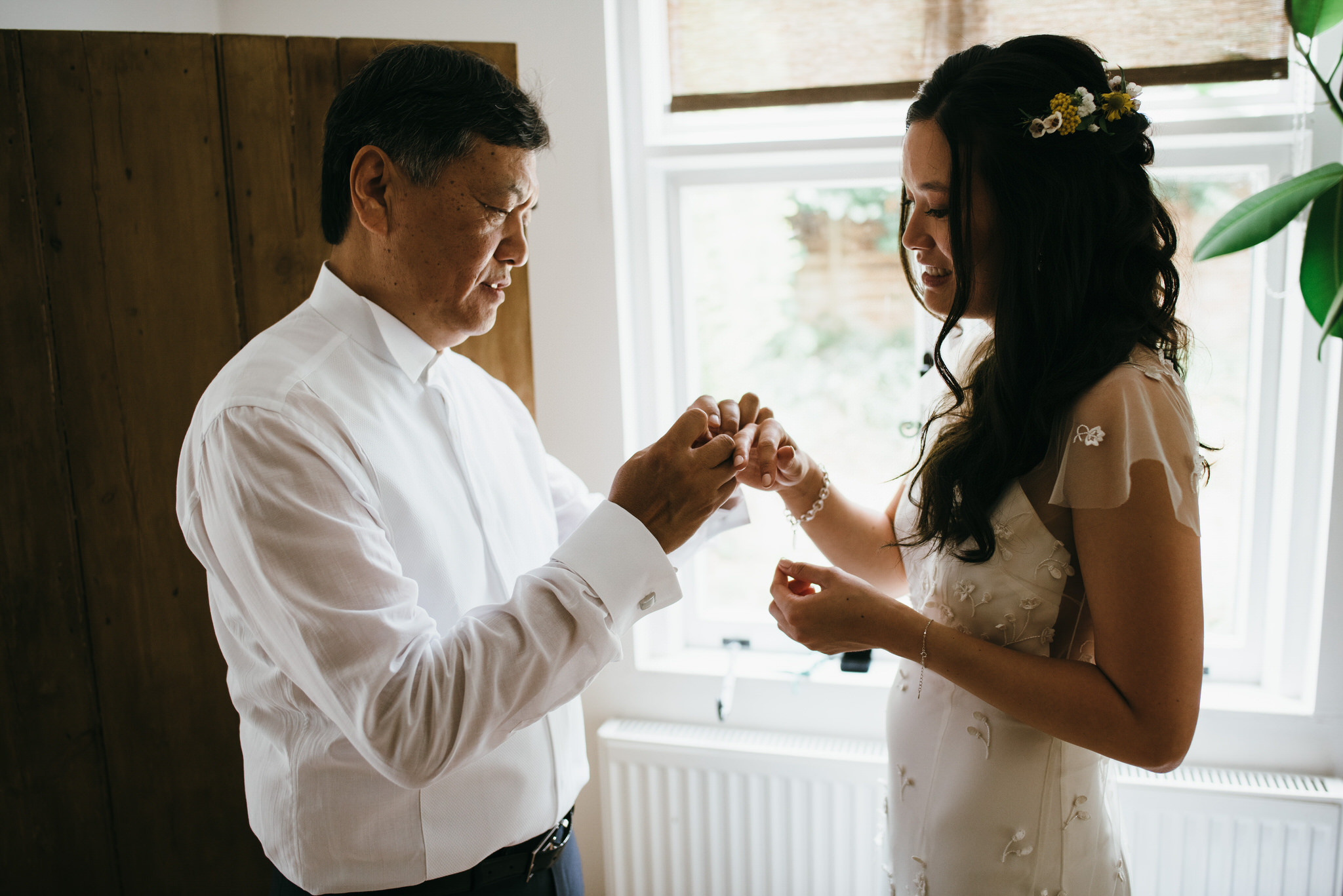 Father helps bride get ready