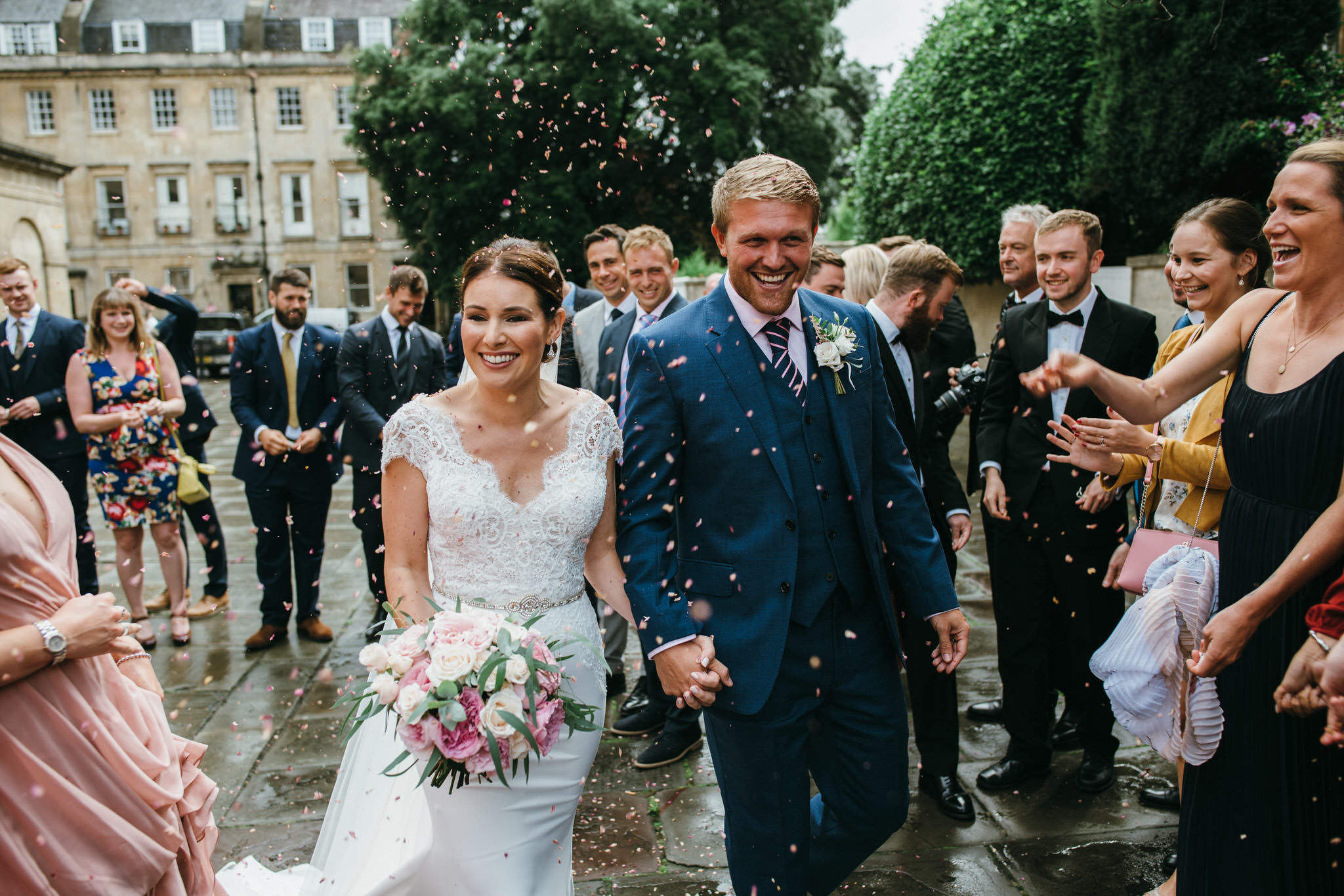 Bride and Groom walk through confetti after their wedding ceremony at the Assembly Rooms, Bath
