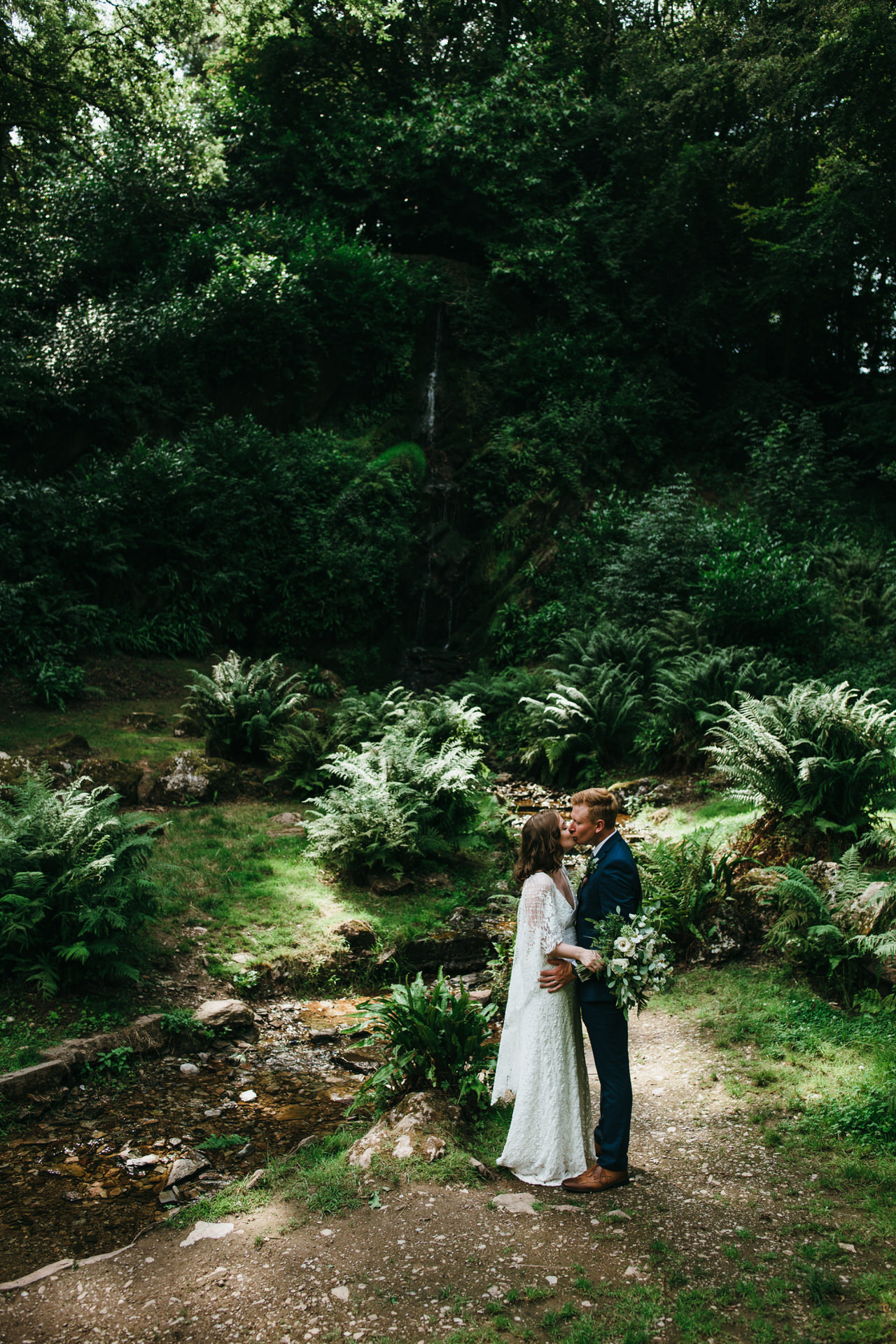 Wedding couple kiss by the cascades at hestercombe gardens
