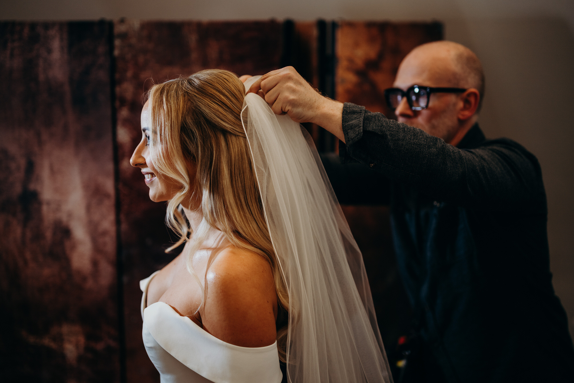 Bride has veil put on at Bury Court