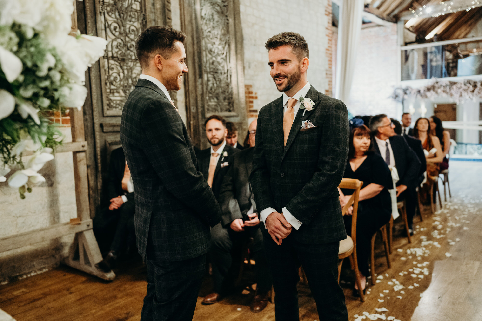 Groom waiting nervously at end of aisle at Bury Court wedding 