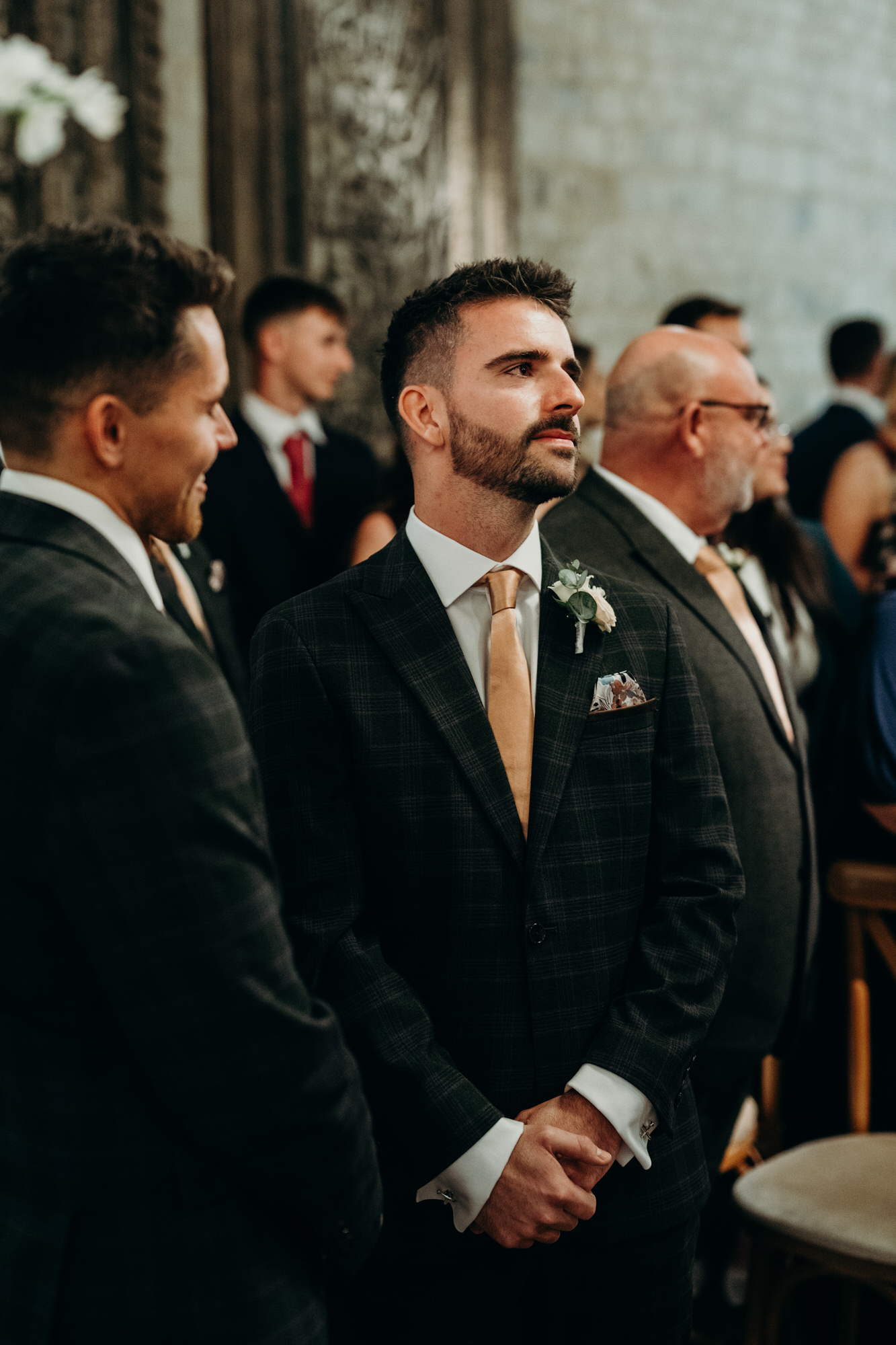 Groom waiting at end of aisle at Bury Court wedding 