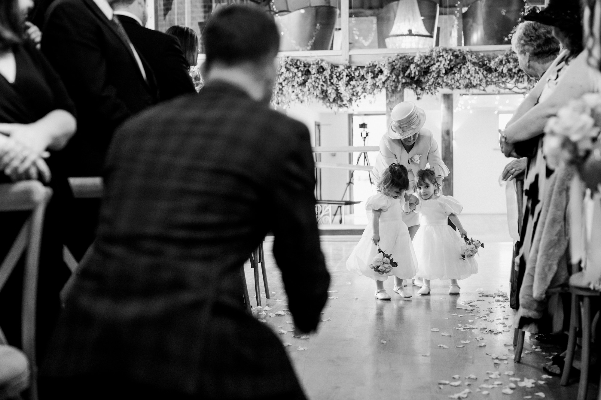 Groom awaits his twin girls at end of aisle at Bury Court 
