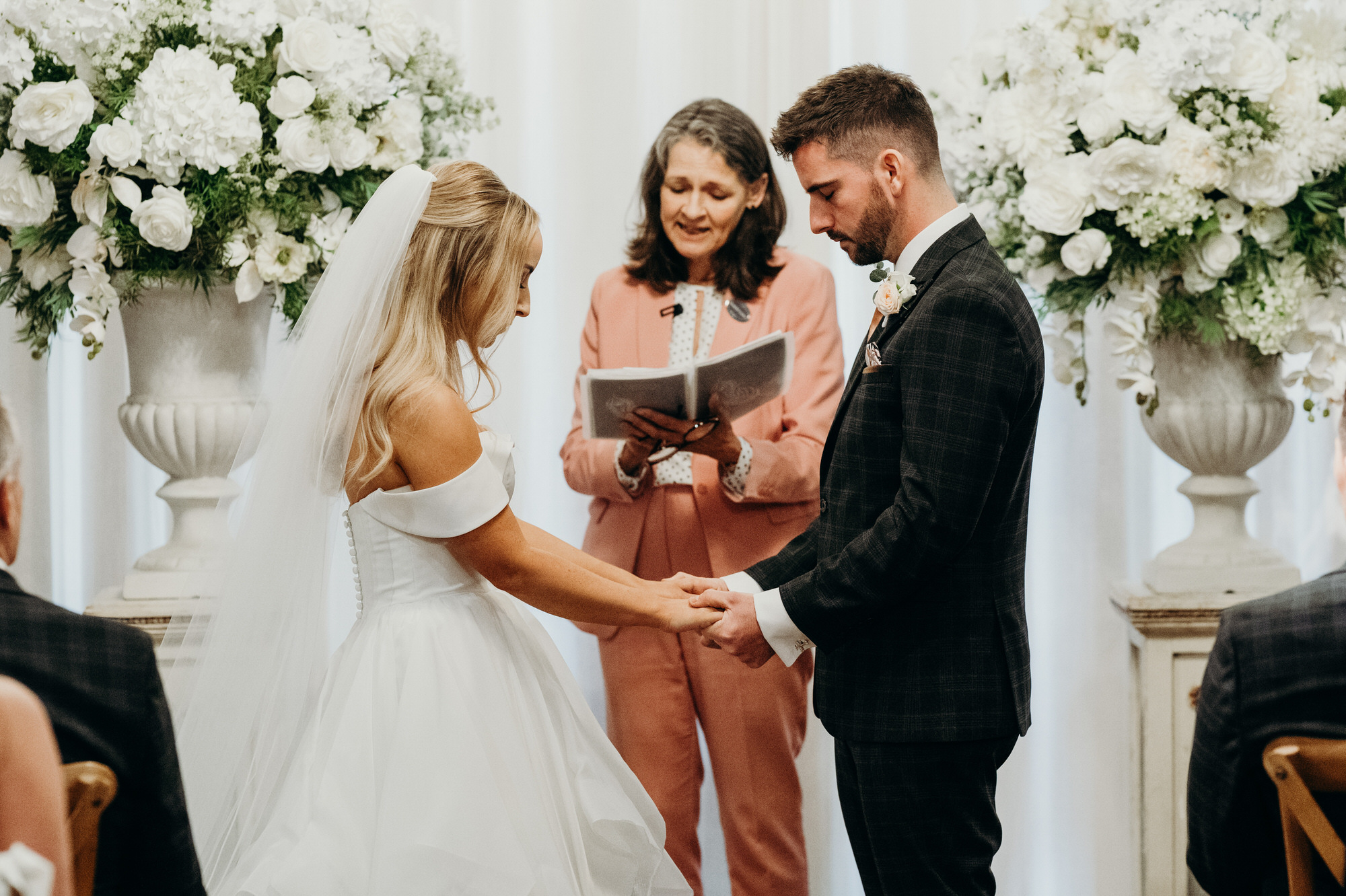 Couple wedding ceremony at Bury Court Barn with autumnal floral arrangements
