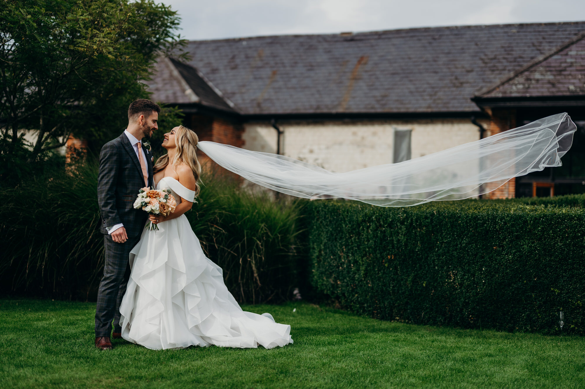 Brides veil catches the wind at a  Bury Court autumn wedding 