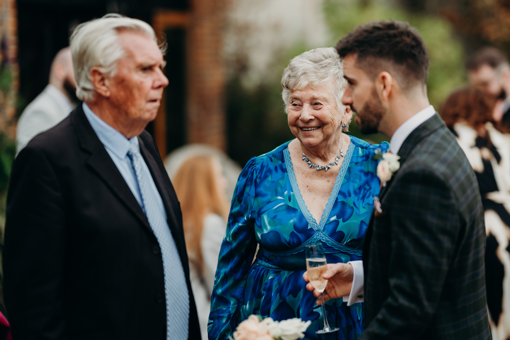 Guests during outdoors drinks reception Bury Court 