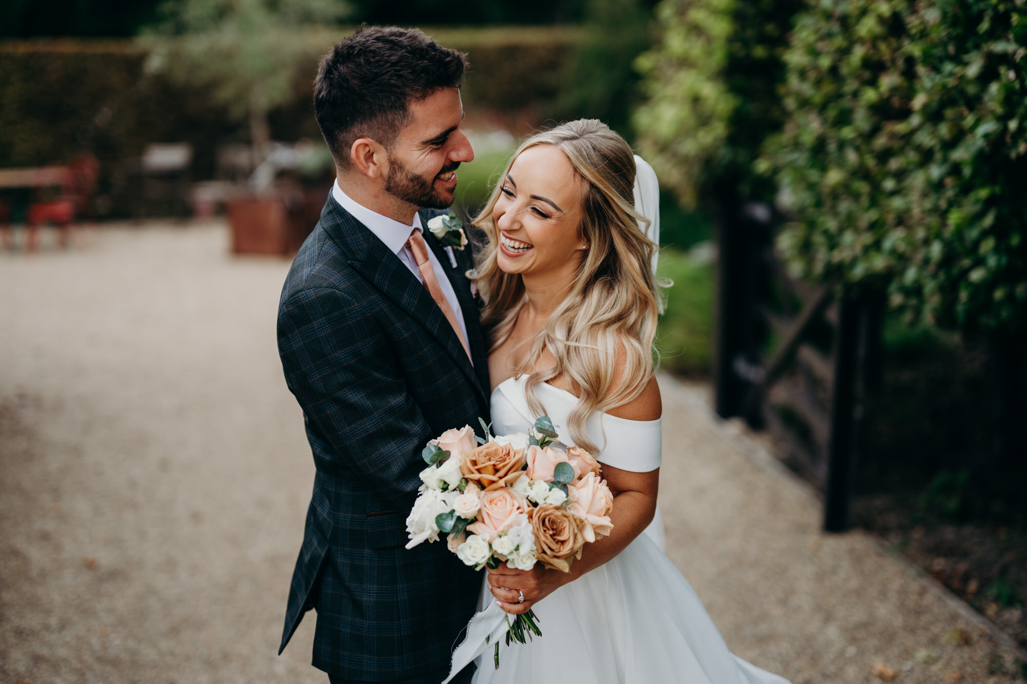 Newlyweds laughing together at Bury Court 