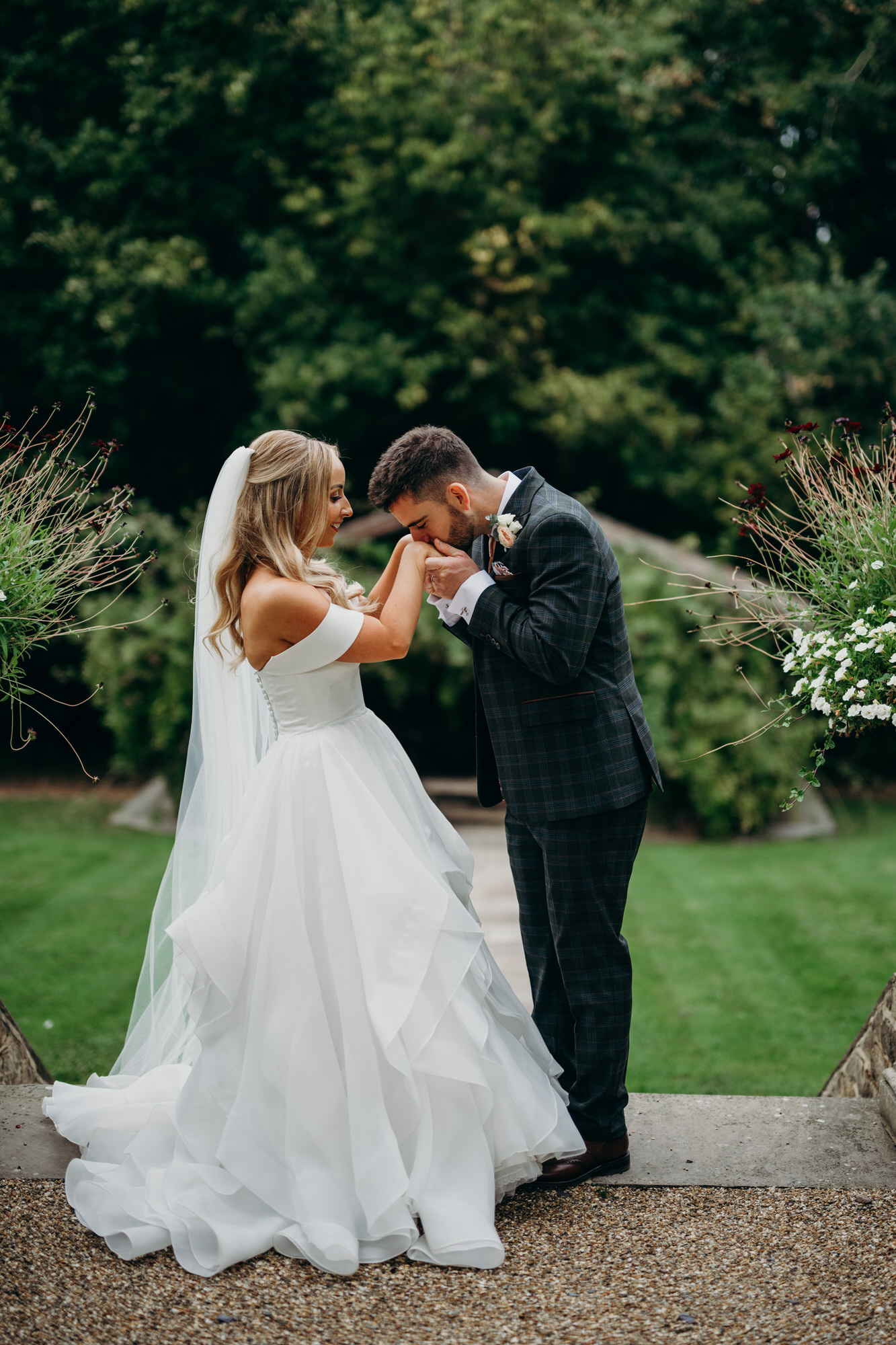 Groom kisses bride hand at Bury Court 
