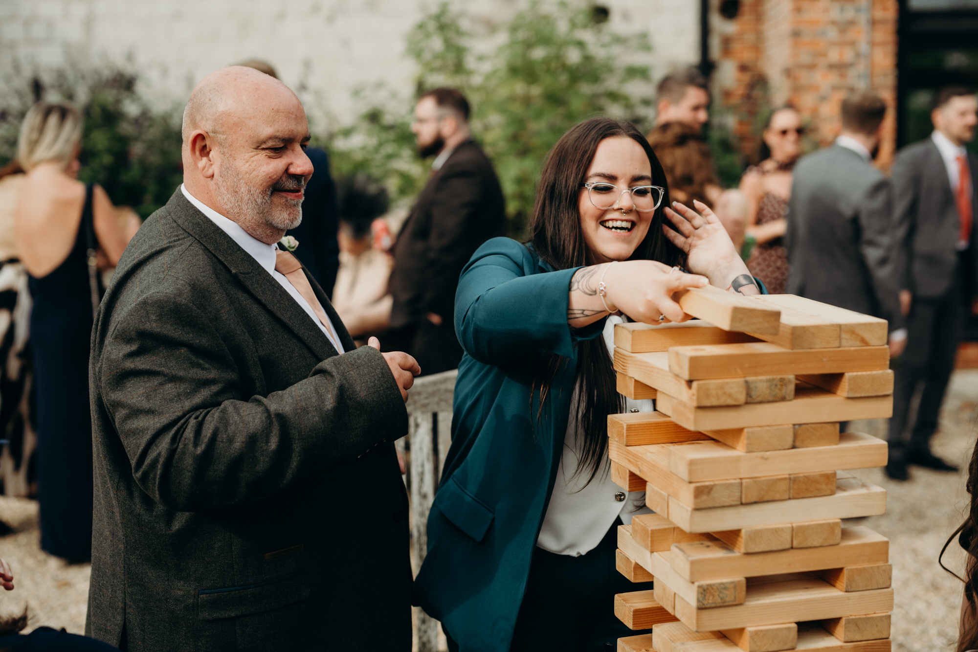 Guests play giant Jenga during outdoors drinks reception Bury Court 