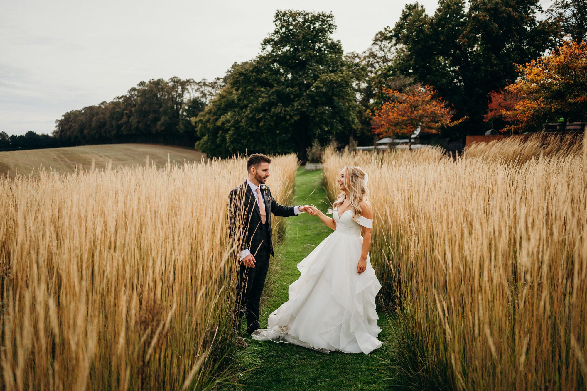 Bride and groom in meadow at Bury Court 