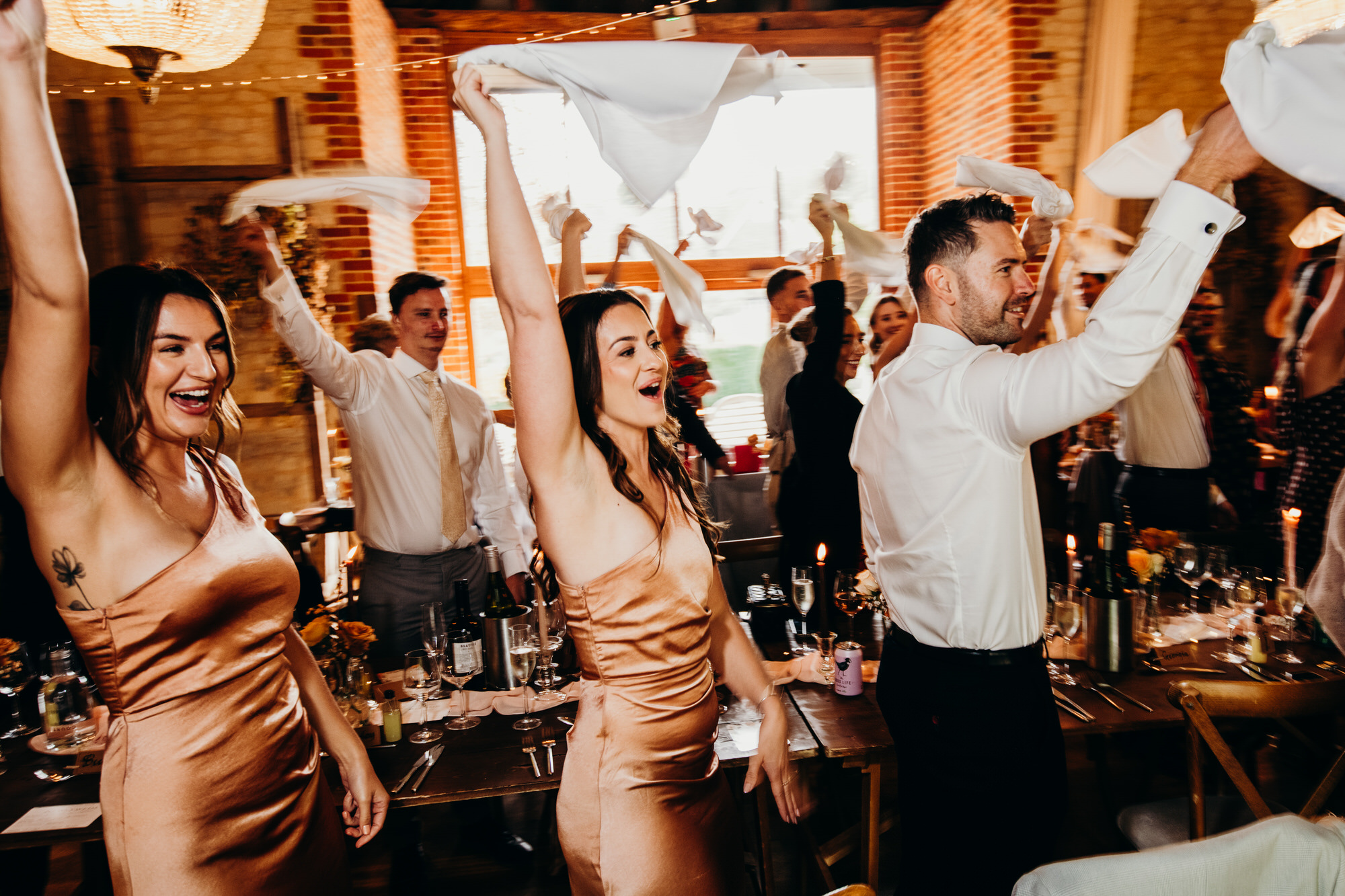Bride and groom enter to napkin waving at Bury Court 