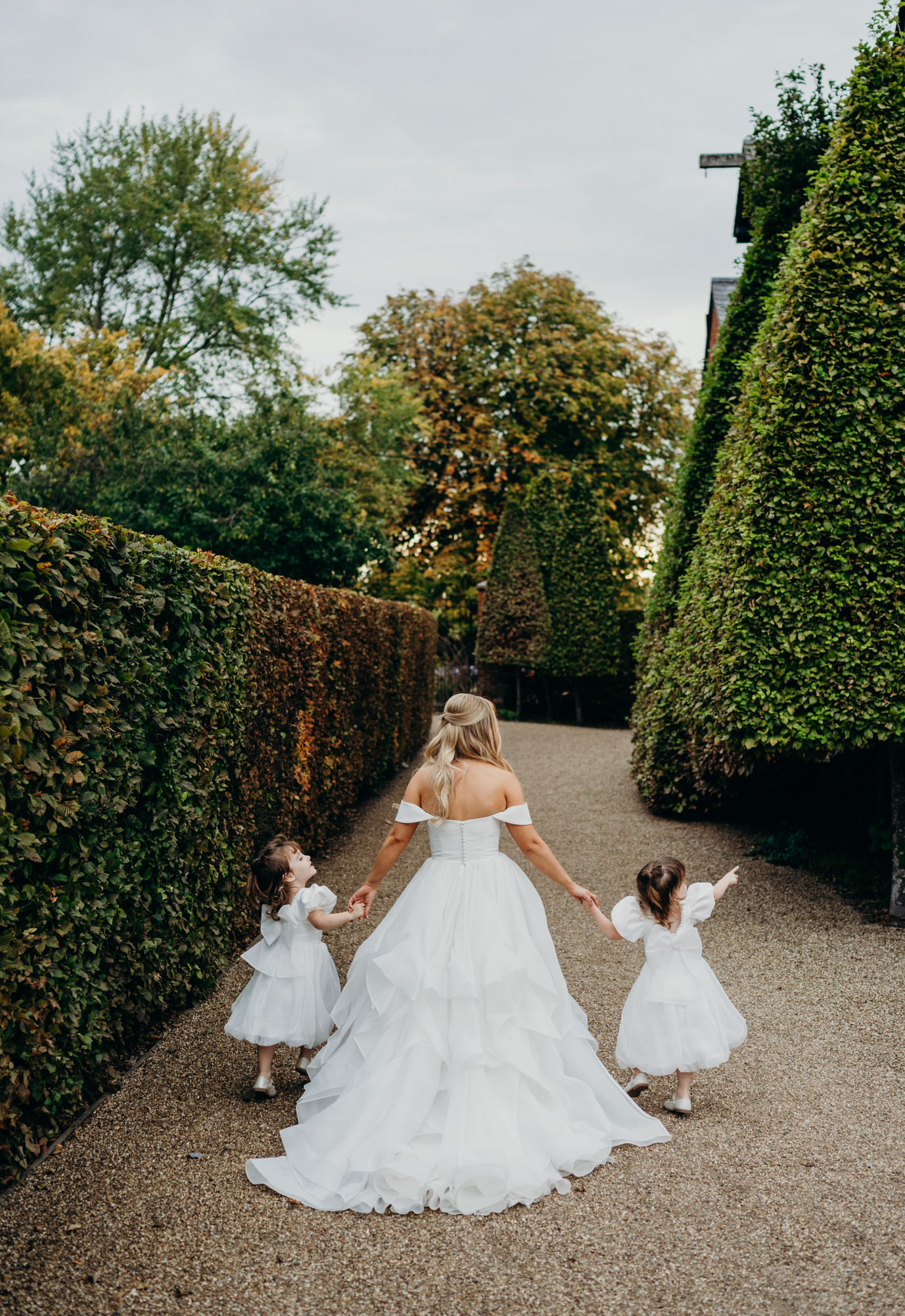 Bride walks with her twin girls 