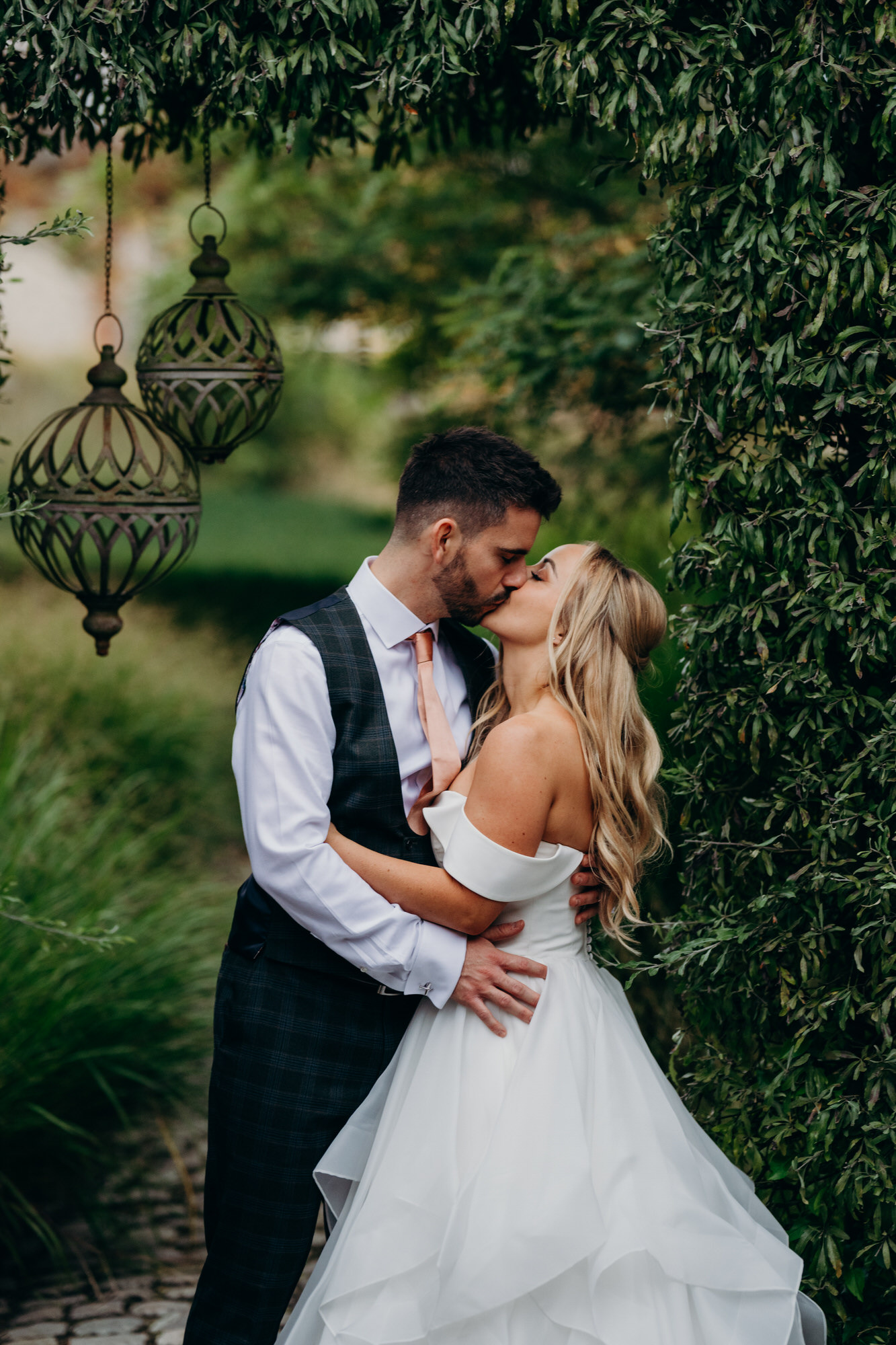 Bride and groom kiss in Bury Court gardens 