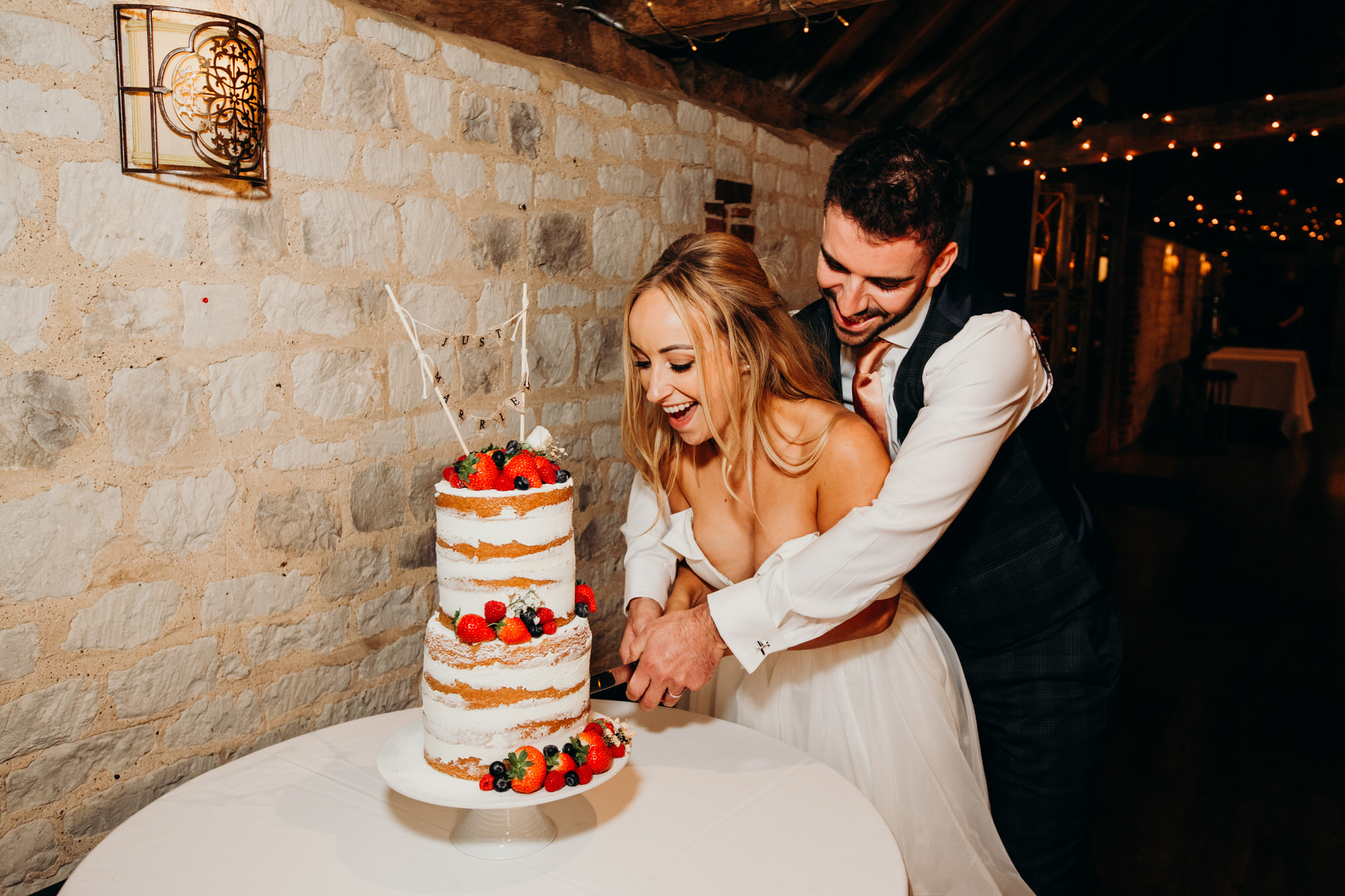 Couple cut the wedding cake at Bury Court 