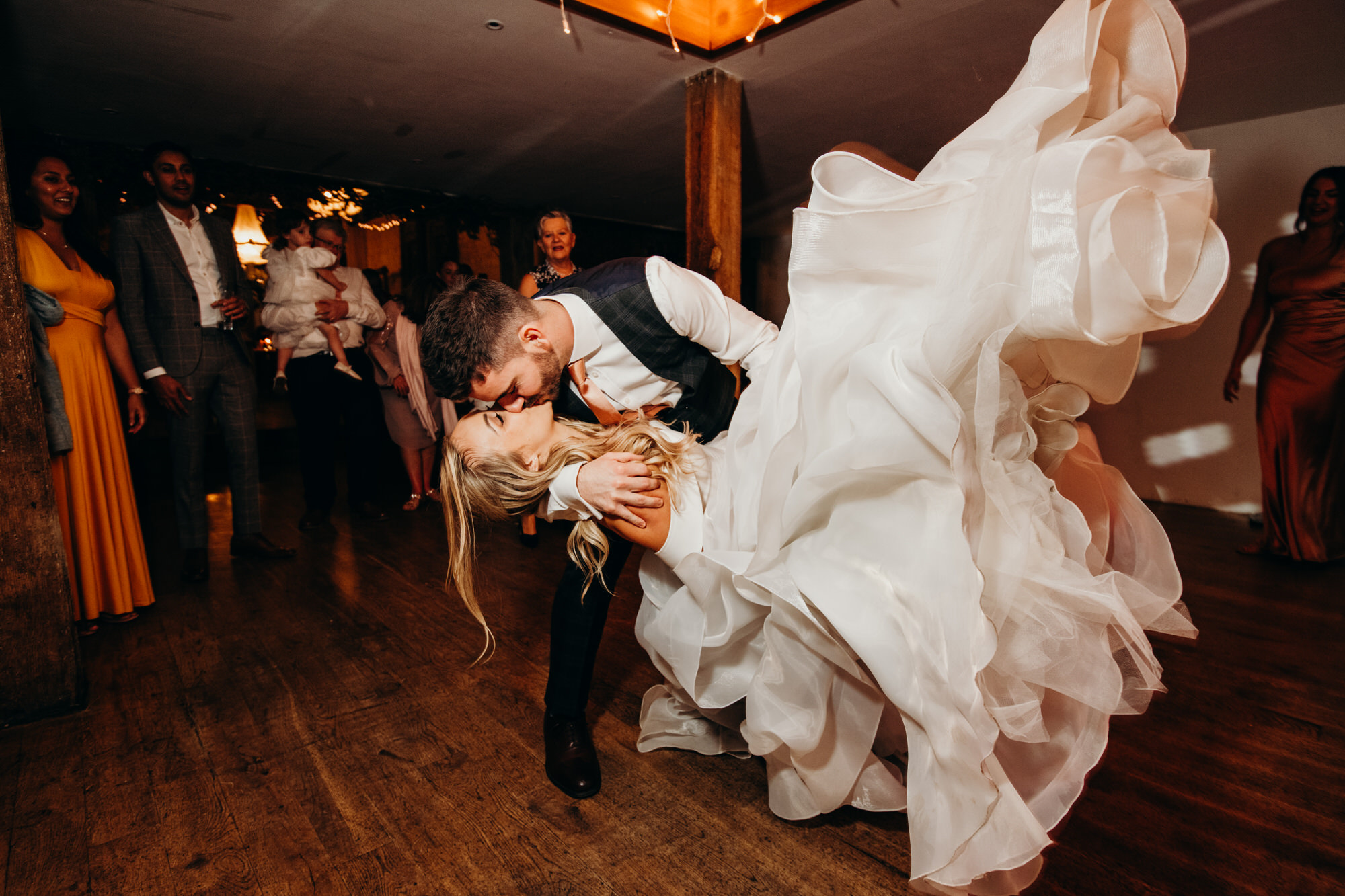 Bride dramatic drop on dance floor with groom 